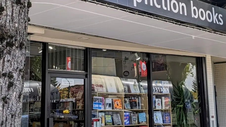 The exterior of Pulp Fiction Books in Vanocuver. There is an awning over the window and lots of books on display.
