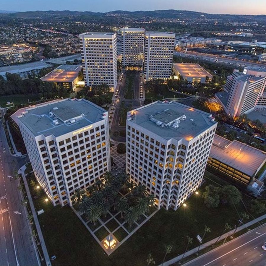 How do repeaters extend two-way radio range?