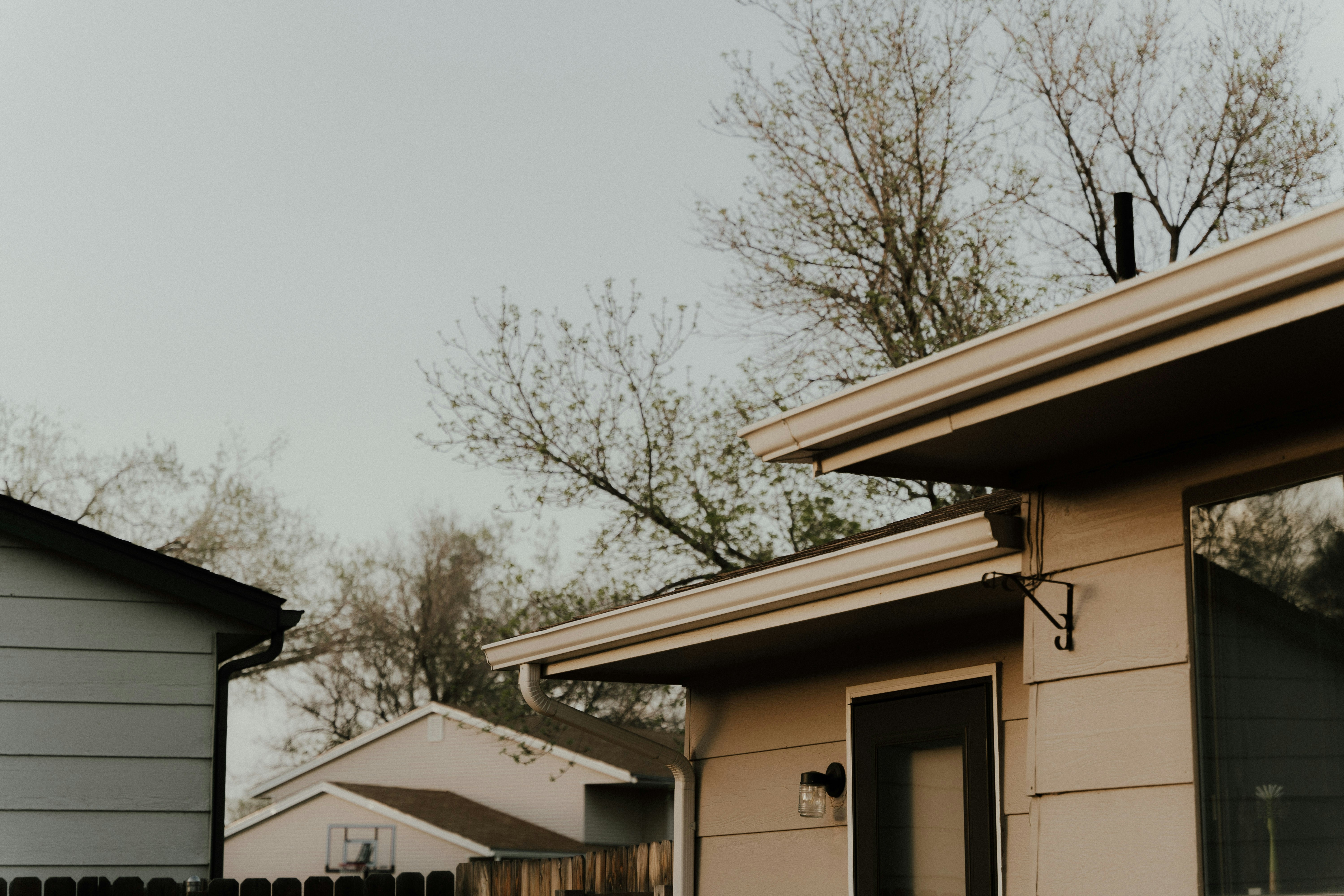 Image Single-story home with gutters and downspouts that need regular cleaning to prevent water damage and costly repairs in North Jersey.