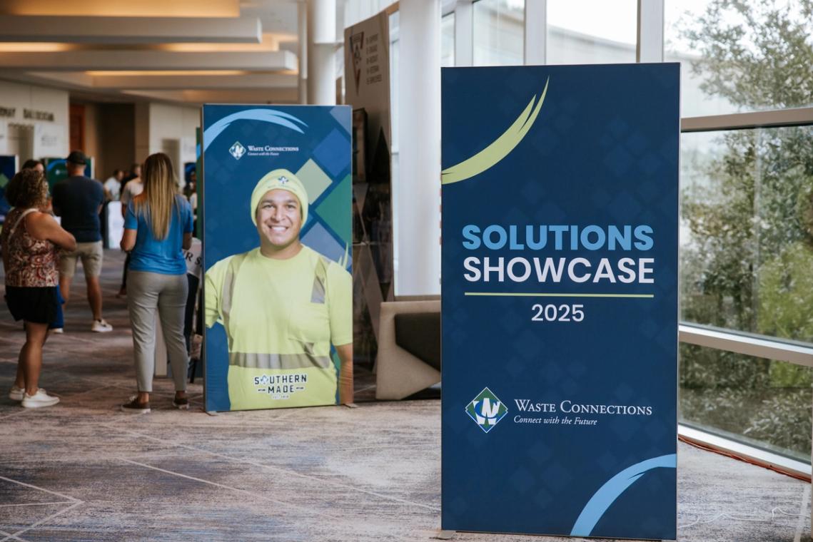 Solutions Showcase 2025 banner and attendee standee in the lobby