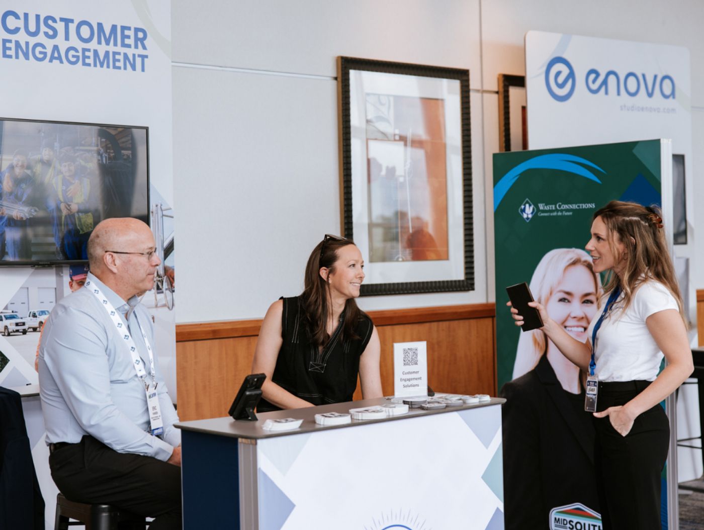 Attendees talking at the customer engagement booth