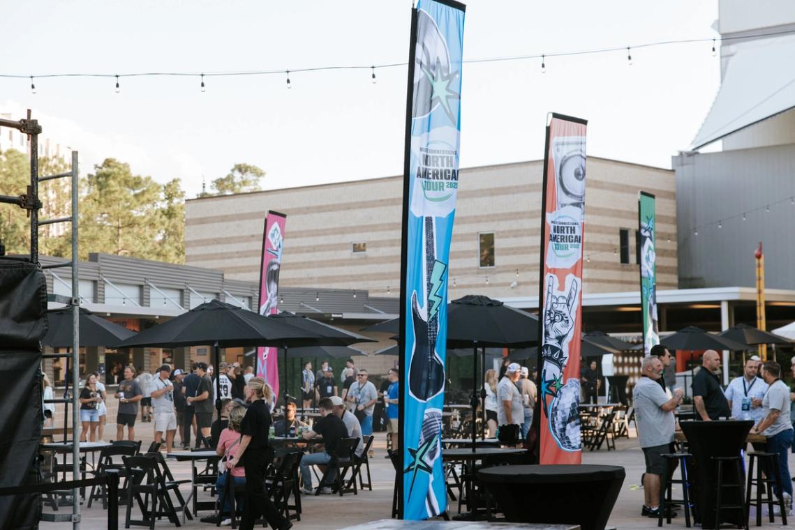 Feather banners and string lights over the outdoor after-party seating