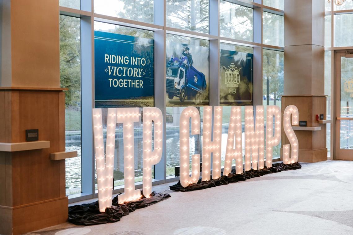Riding into Victory Together window graphics behind VIP CHAMPS marquee letters