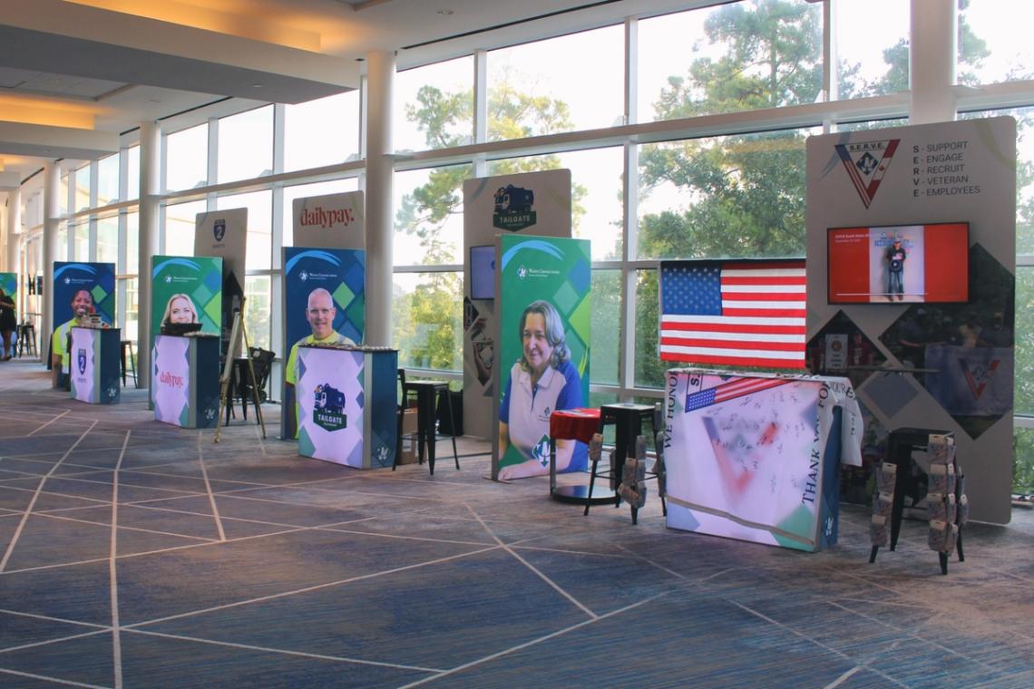 Convention centre concourse lined with Win from Within exhibitor boards