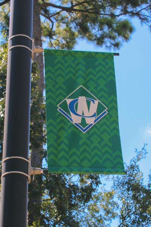 Waste Connections pole banner against the trees outside the venue