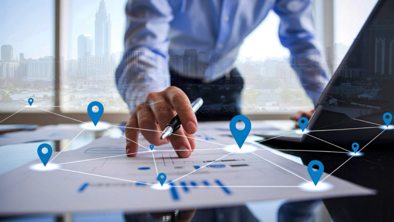 A person pointing at a digital map. 