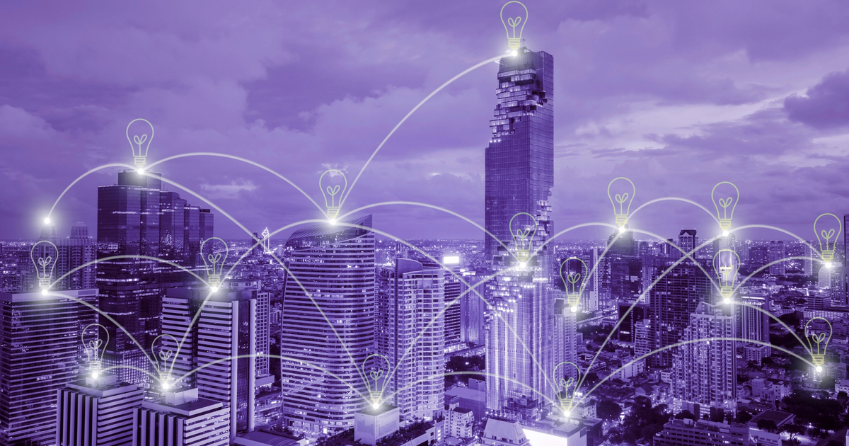 A digital illustration of a cityscape at night with glowing light bulb, emphasizing how to cut costs with energy-saving tips.