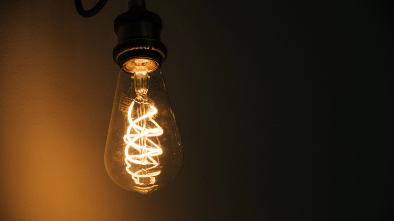 Glowing light bulb featured in "How to Cancel Automatic Energy Contract Renewals for Australian SMBs."