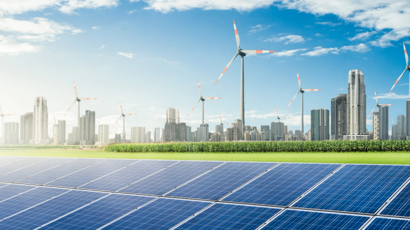 Solar panels and wind turbines representing renewable energy infrastructure for Australian businesses.