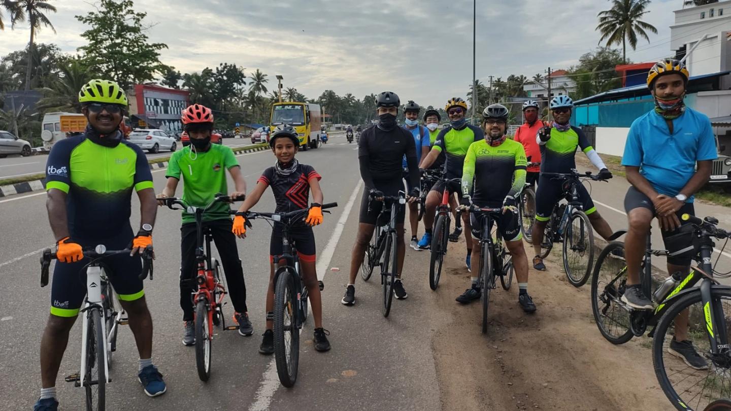 Children with their bicycles alongside Trivandrum Bikers Club cyclists.