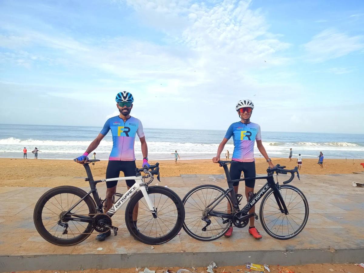 Juan with his coach Renjith C of RaceFit Coaching, both with road bikes at the beach