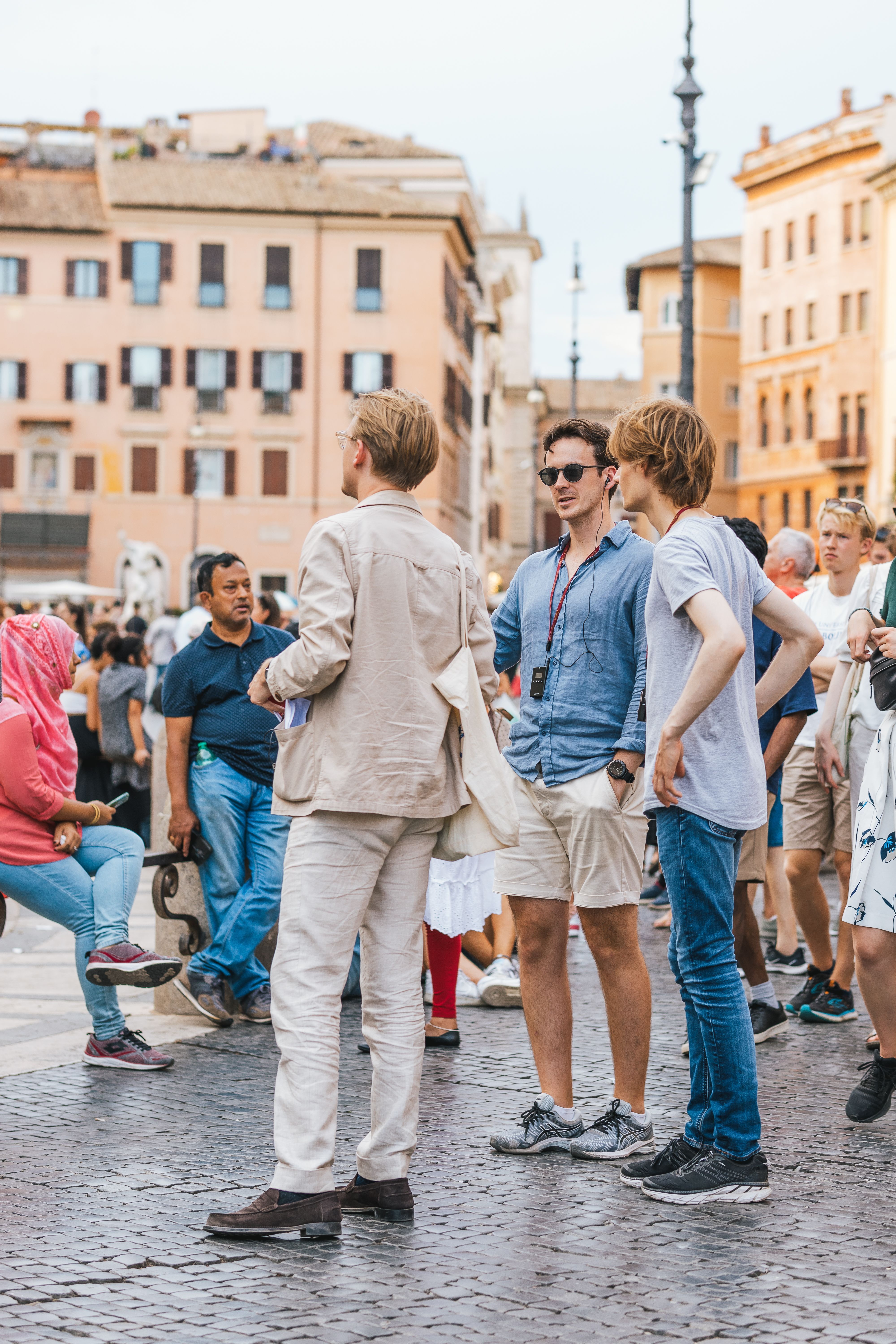 People enjoying a summer day in Piazza Navona, Rome, with historic architecture.