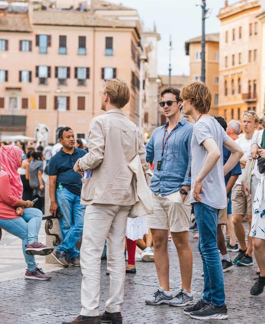 People enjoying a summer day in Piazza Navona, Rome, with historic architecture.