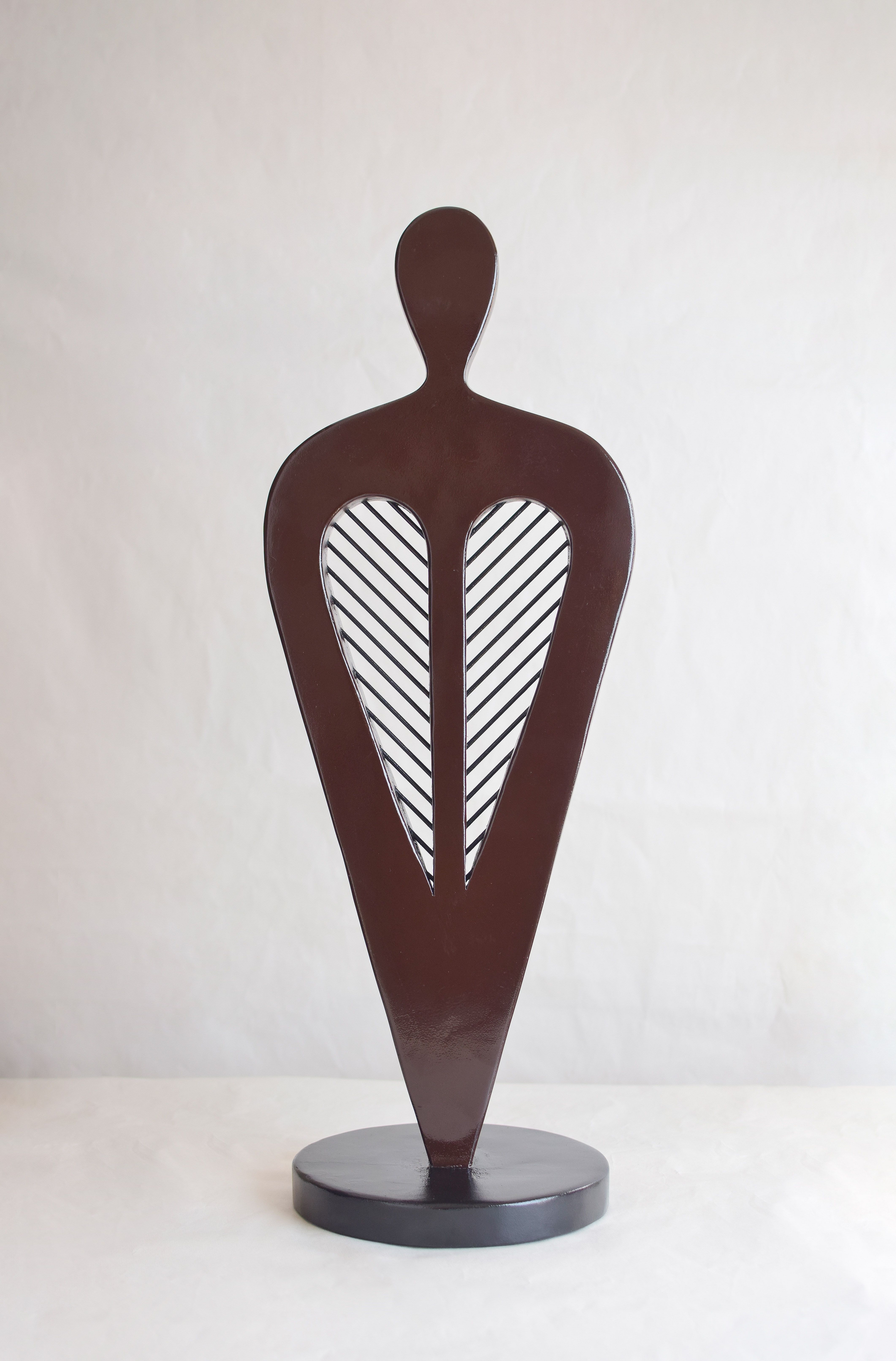 A wood work by Uzor Ugoala depicting the folded wings of a bird