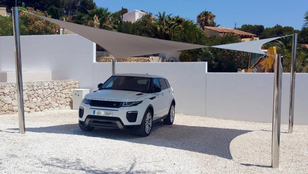 Dual shade sail carport covering an SUV on a driveway