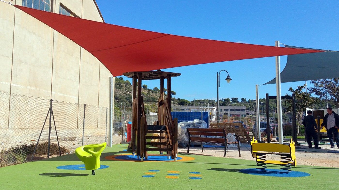 Commercial shade sails installed above a children's playground area for sun protection