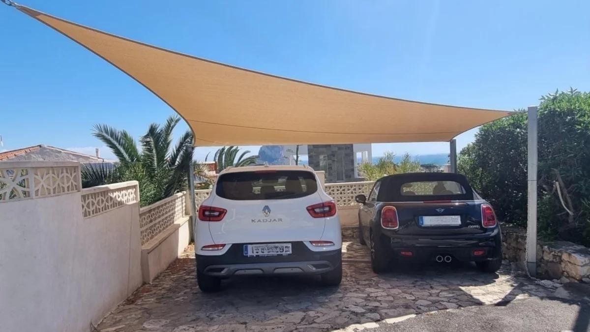 Custom triangular shade sail installed over residential carport on the Costa Blanca