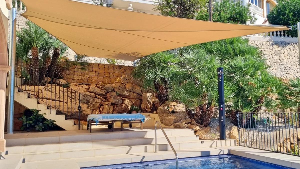Large custom shade sail installed above a private pool terrace in Jávea