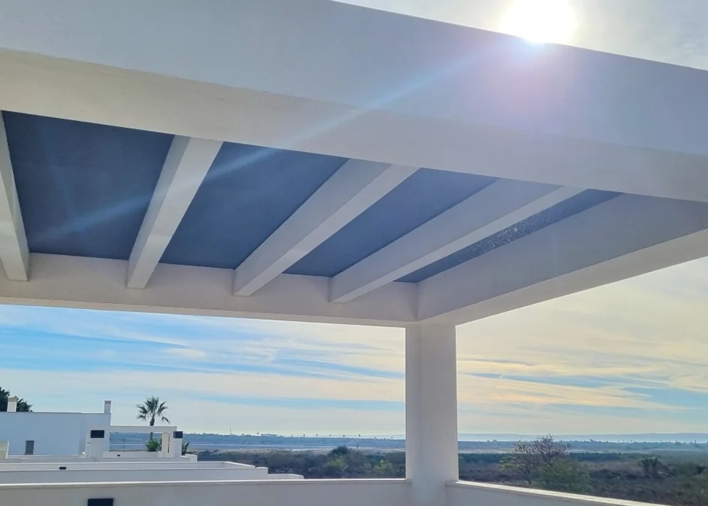 Fixed shade panels in a pergola roof on a rooftop terrace