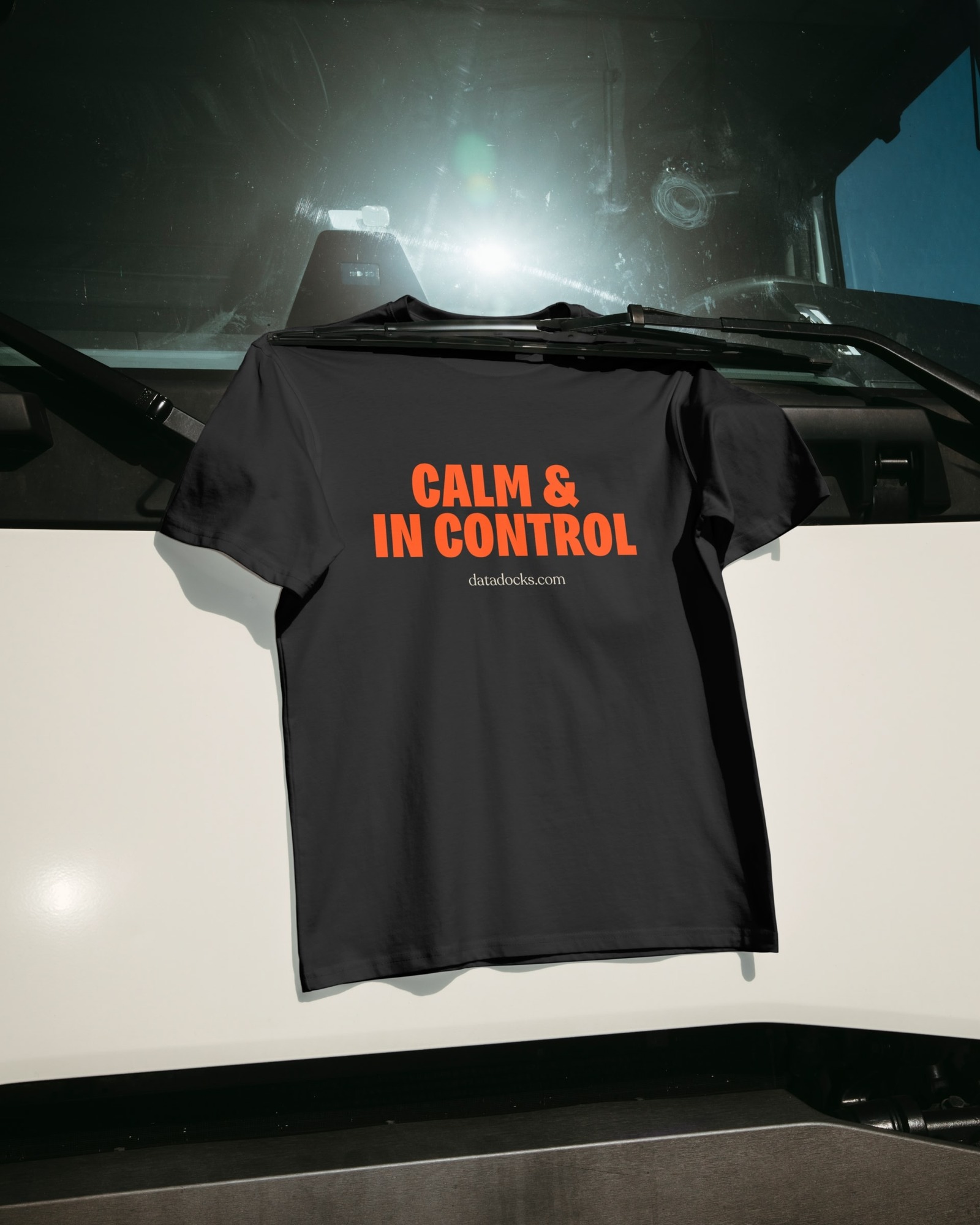 Black DataDocks shirt reading Calm and In Control displayed on a truck