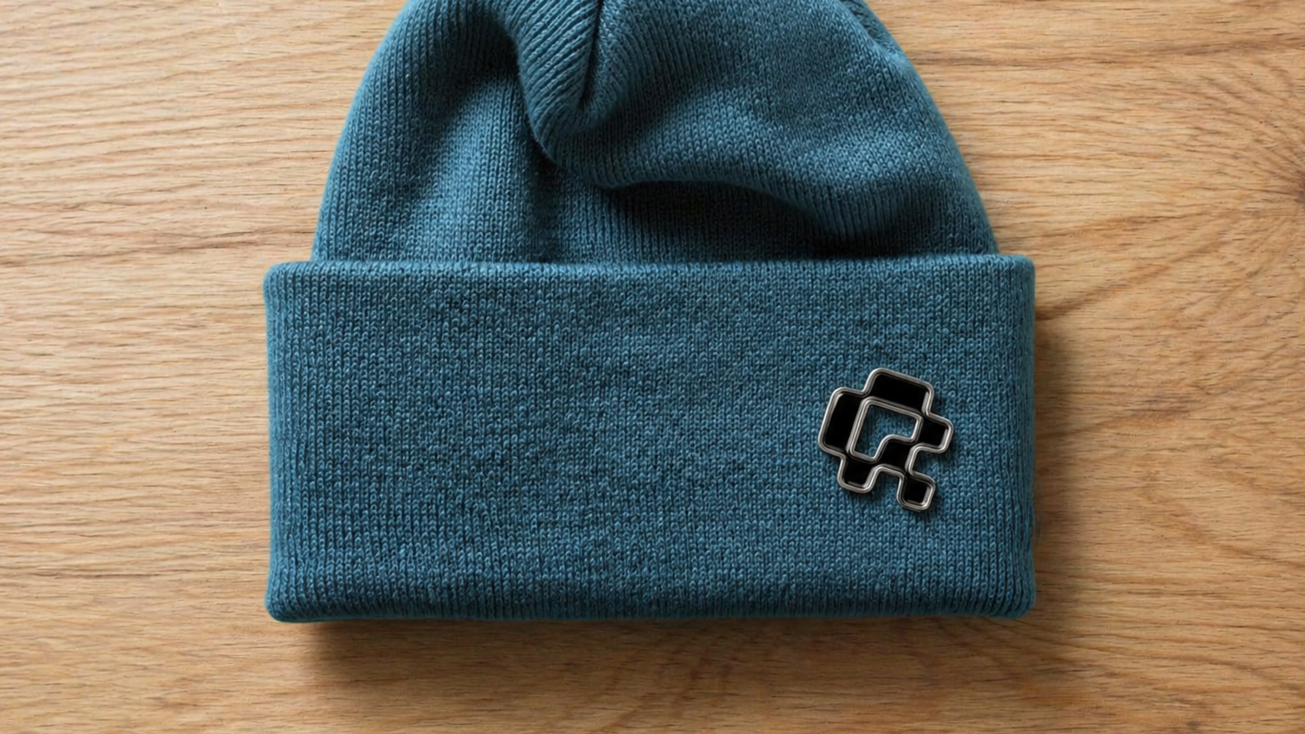 Blue beanie with a black QR-Codes.com symbol pin