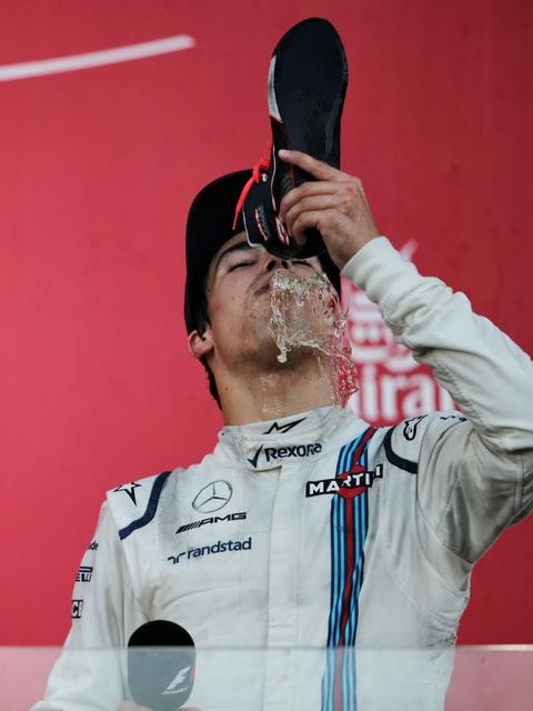 A fresh-faced Lance Stroll partakes in a shoey in Baku after becoming the youngest rookie and second youngest driver in history to stand on the F1 podium – 2017