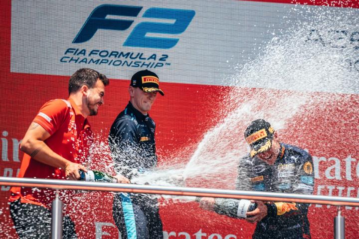 Logan Sargeant celebrates on the Formula 2 podium in Baku, Azerbaijan.