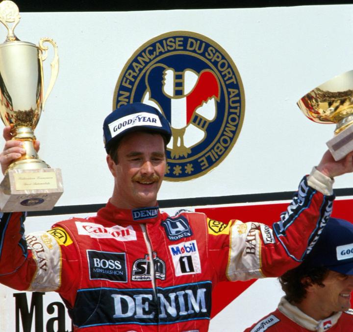 Nigel Mansell celebrates on the podium after winning the 1987 French Grand Prix
