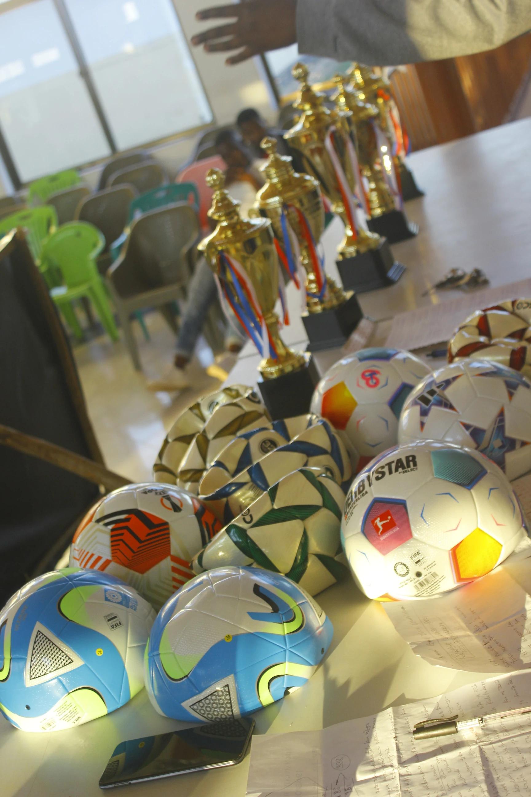 Trophies and match balls arranged on a table