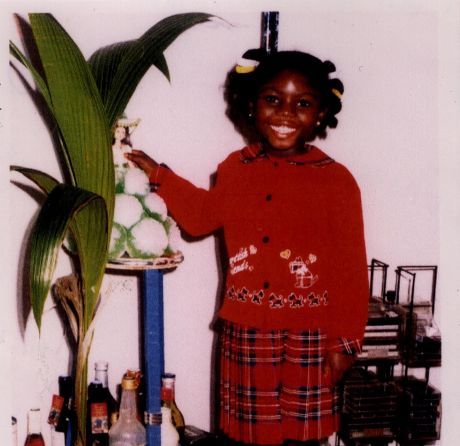Little girl smiling and holding a doll