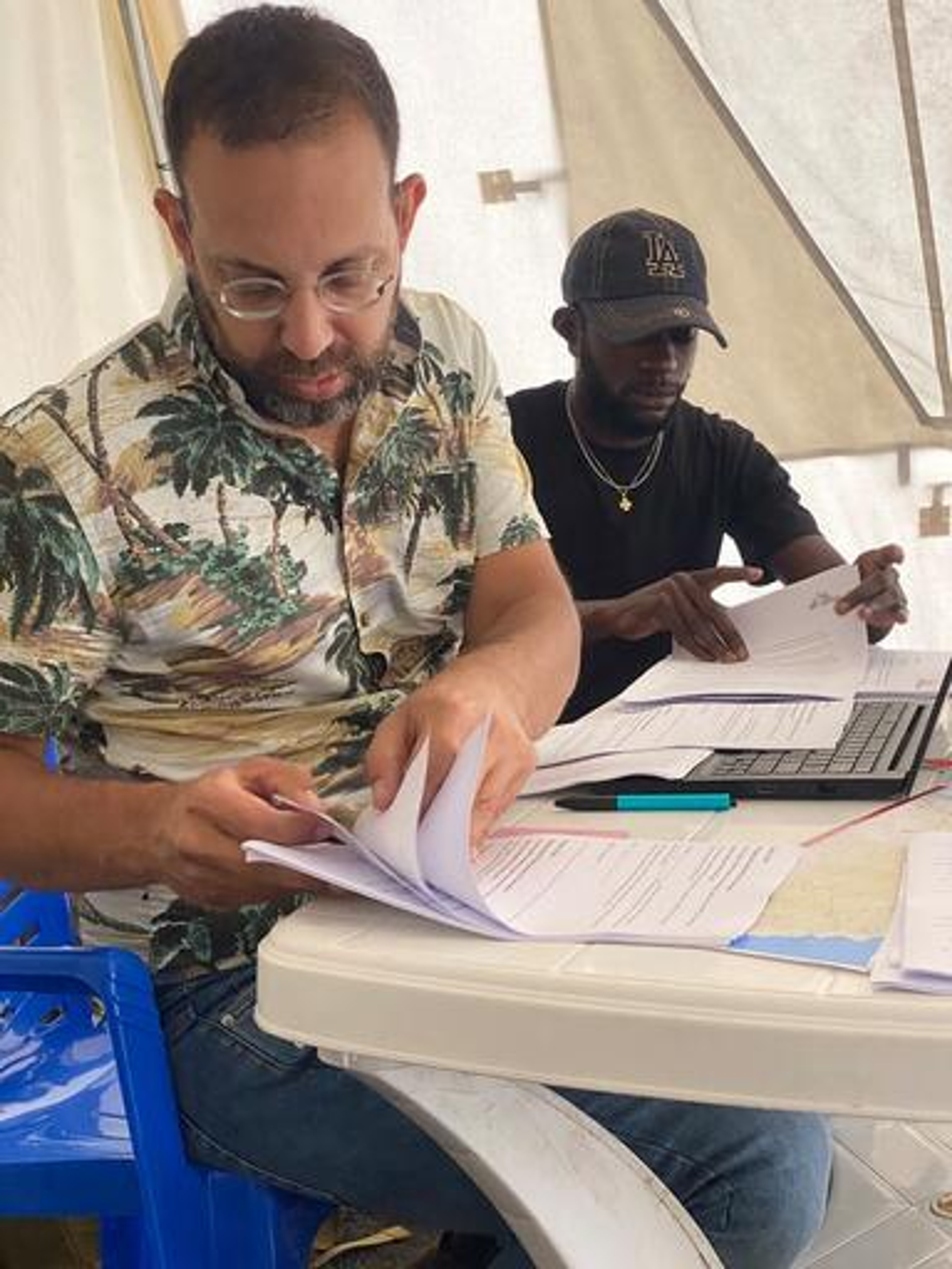 George Karanapagos, Public Health Data Analyst, and his colleague coordinating a field survey