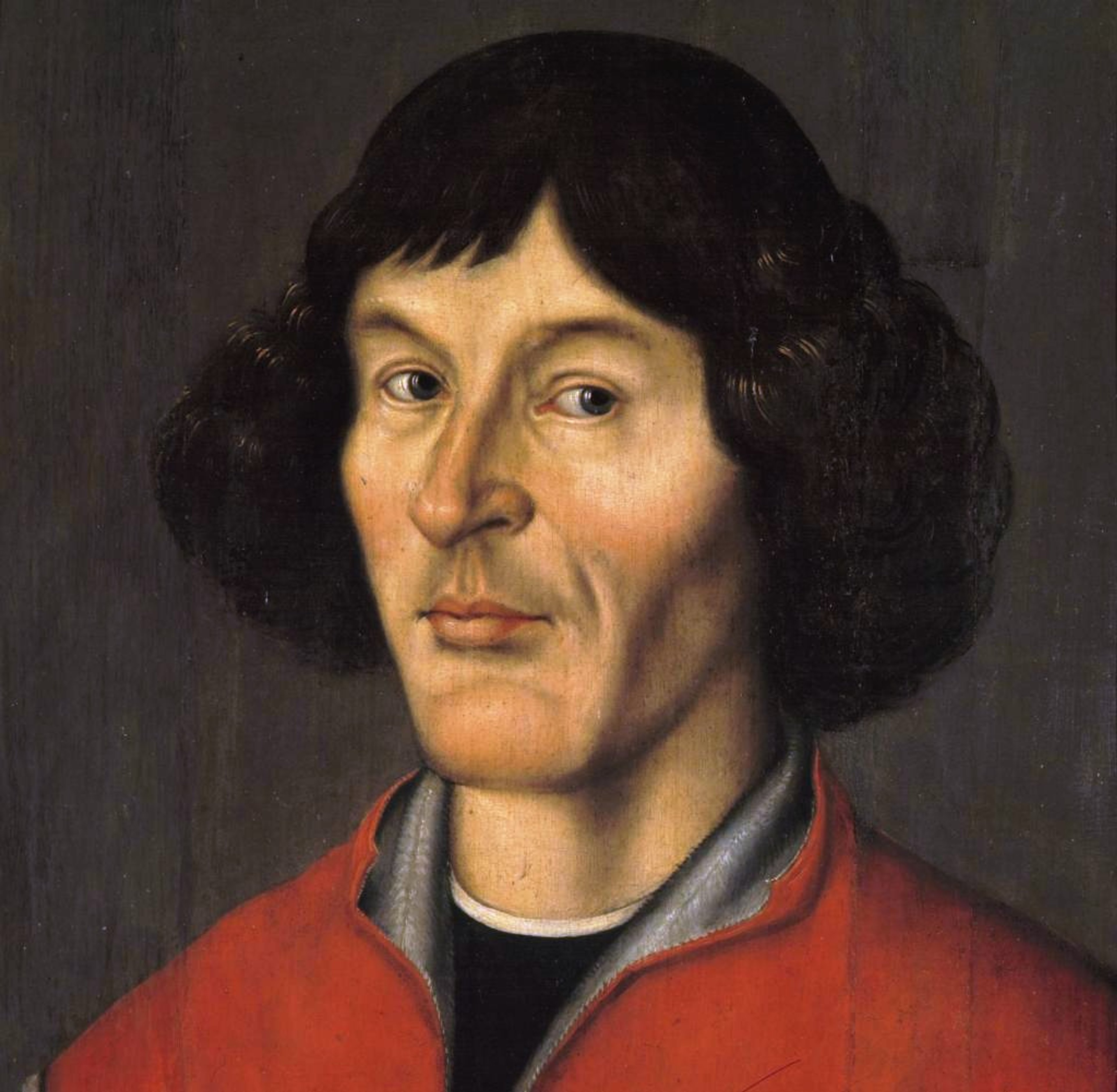 Close up portrait of the head and shoulders of Nicholas Copernicus, a man with long black hair, who's wearing a red robe.