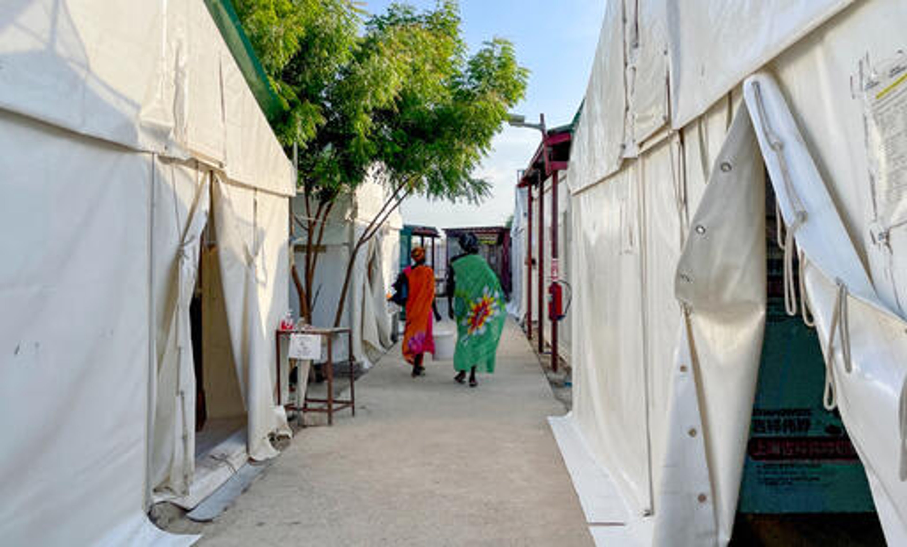 Two patients are walking inside MSF hospital in Leer, Unity State, South Sudan. May 2024