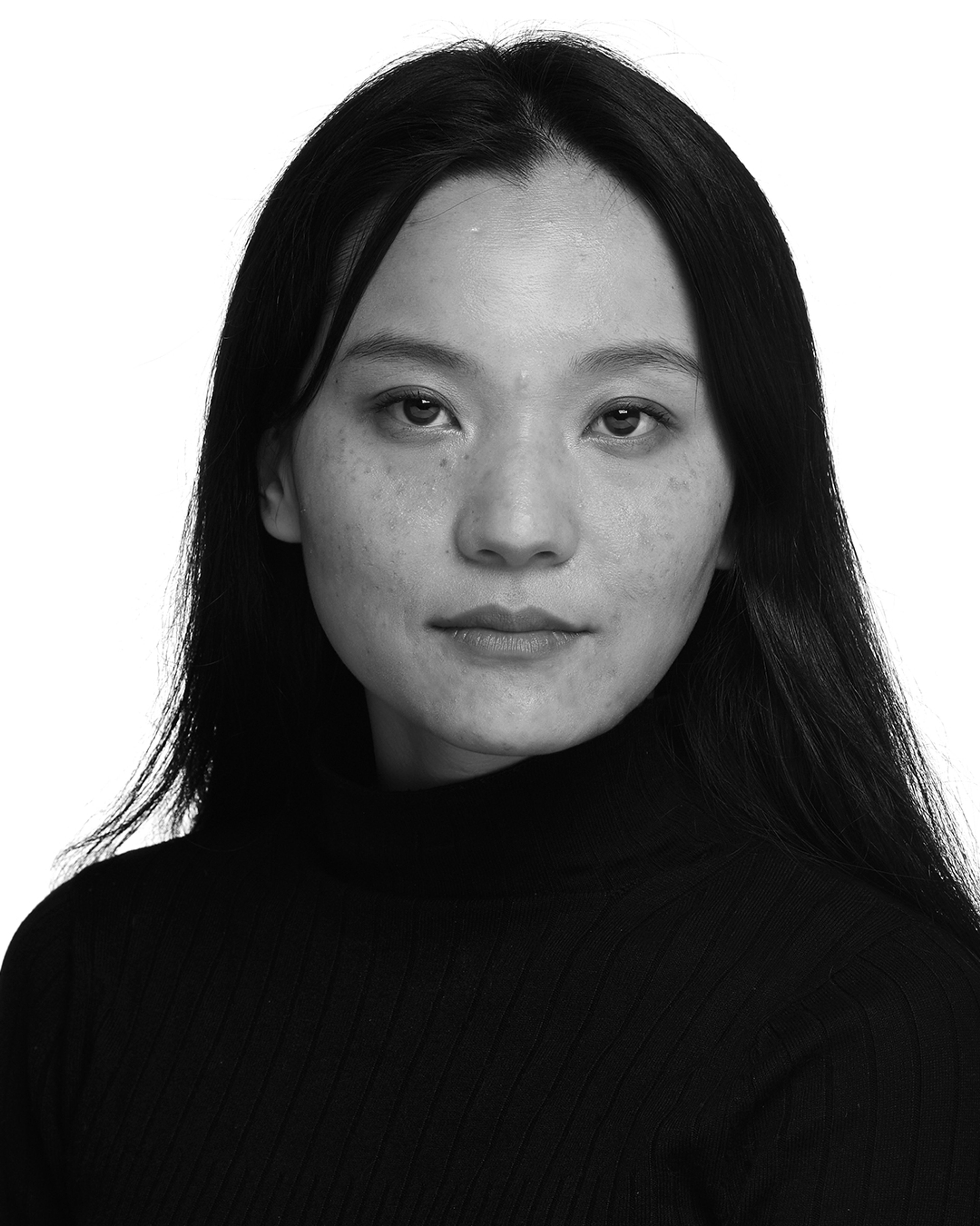 A professional black and white portrait of Rohini, a Kiratindigenous (Khambu) - Sikkimese woman wearing a black top
