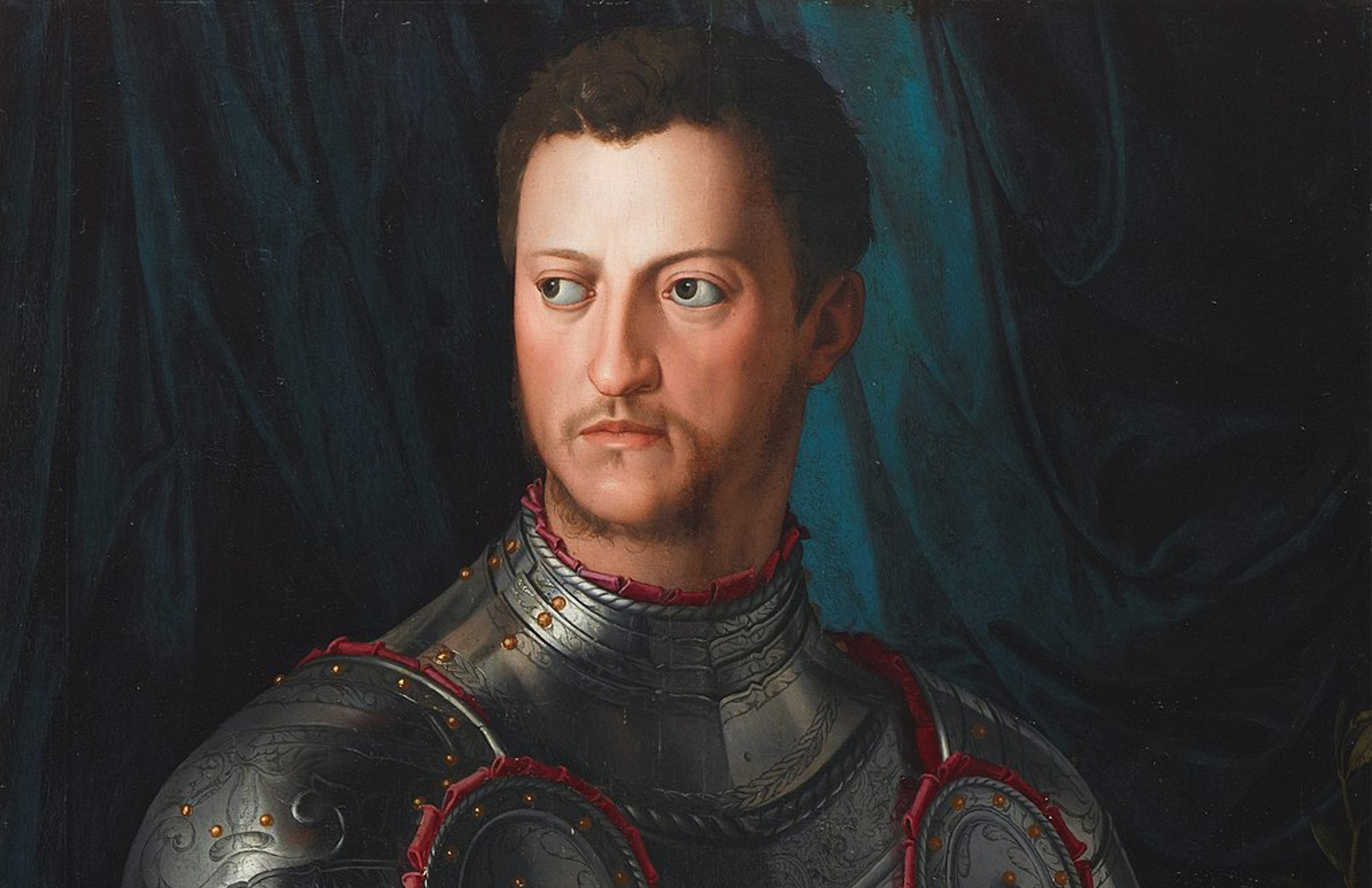 Colourful portrait of Cosimo I de' Medici, Grand Duke of Tuscany, a man with short brown hair, wearing a suit of armour and resting his right hand on a helmet.