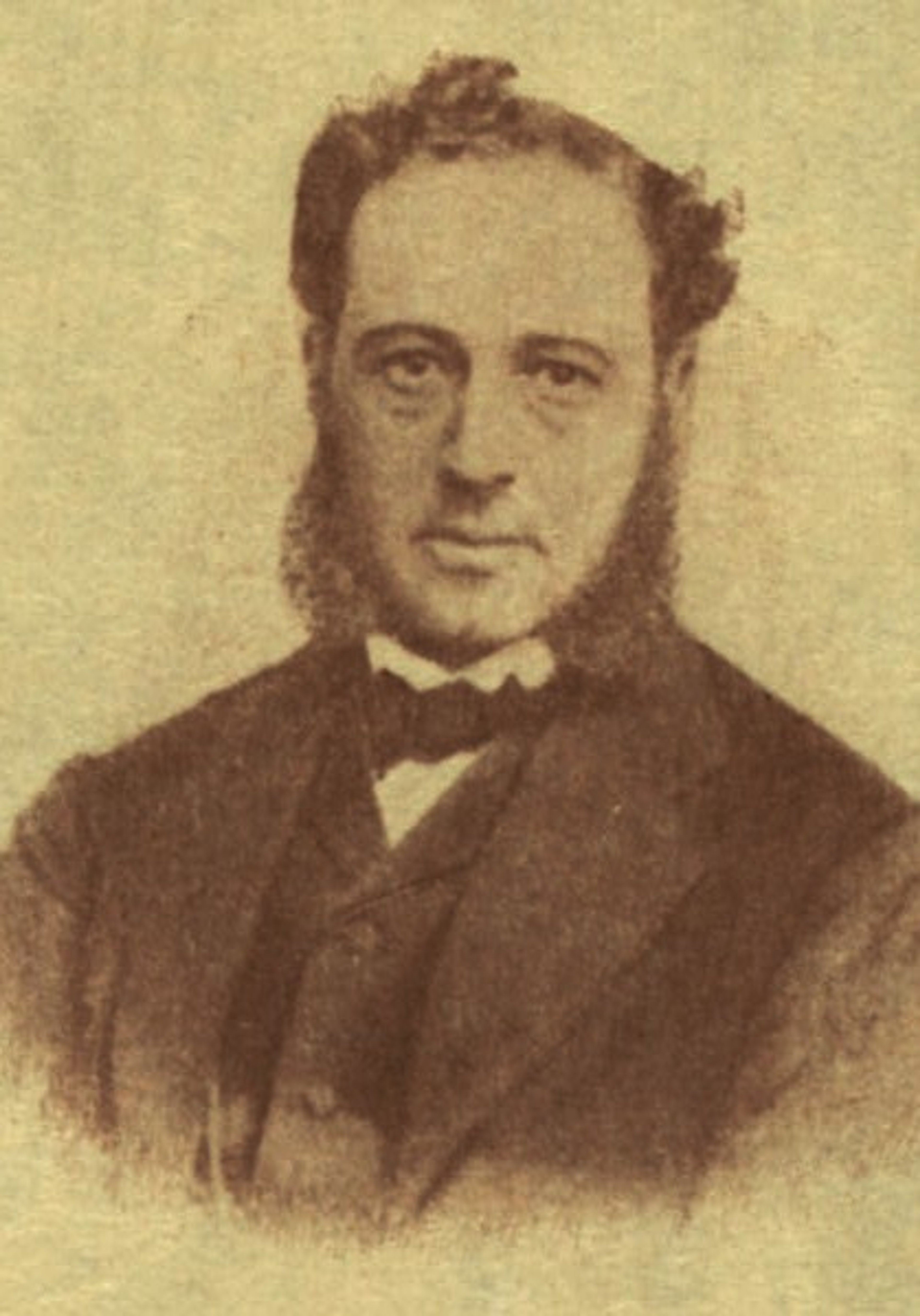 Photographic portrait of Henry Harisse, a man with short hair and wearing a dark suit with a bow tie.