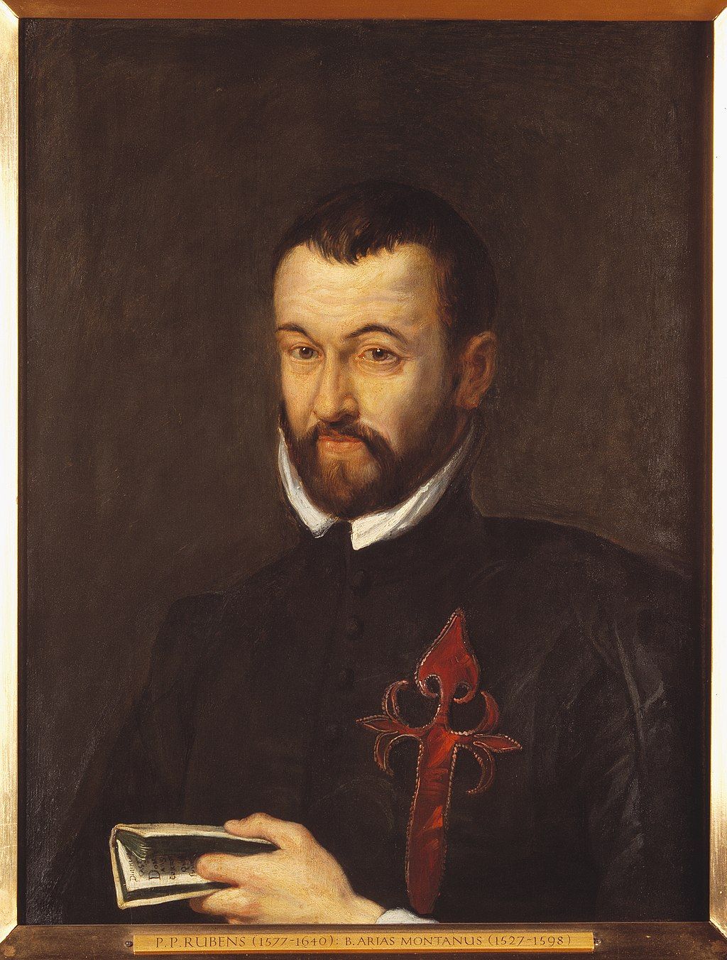 Colourful portrait of the upper body of Benedictus Arias Montanus, a man with short brown hair and a beard. In his left hand he's holding a pamphlet.