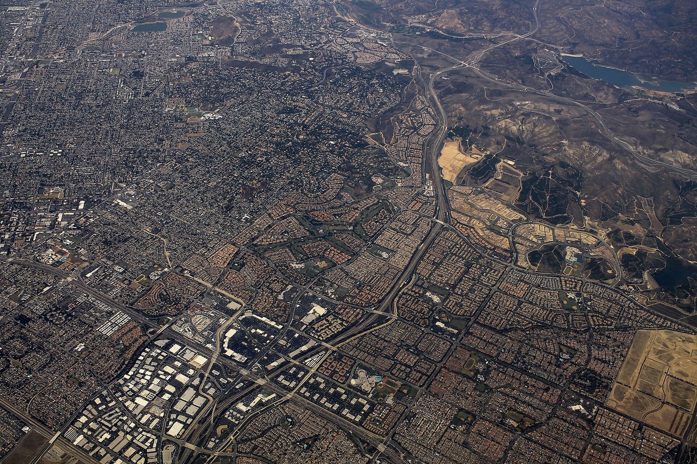 Aerial photograph of master-planned Tustin and Irvine, showing curving arterials and separated subdivisions