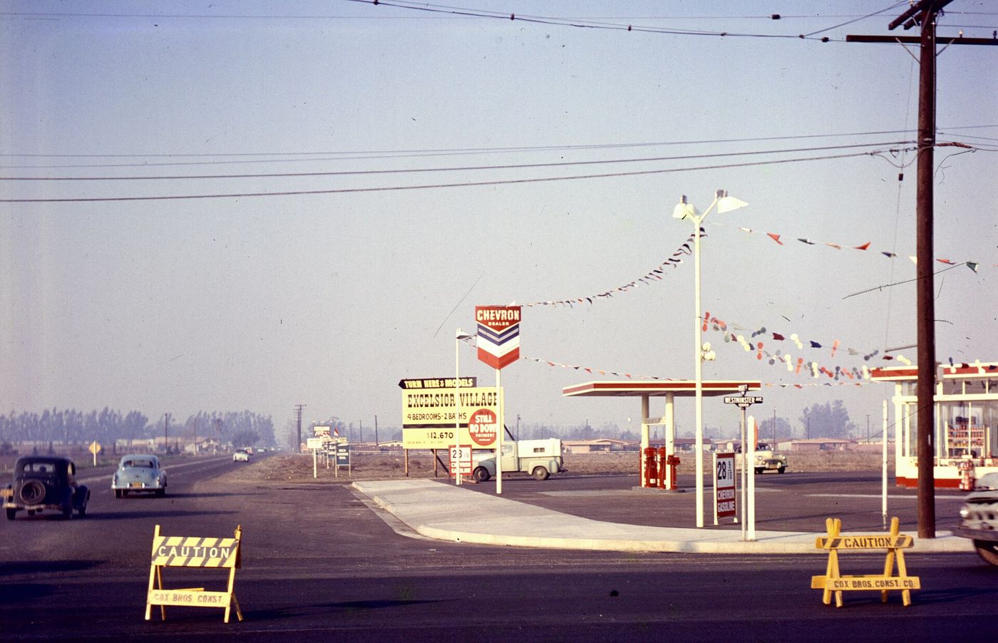 Westminster Avenue at Brookhurst Street in Garden Grove, January 1957, with new tract housing rising behind a rural intersection
