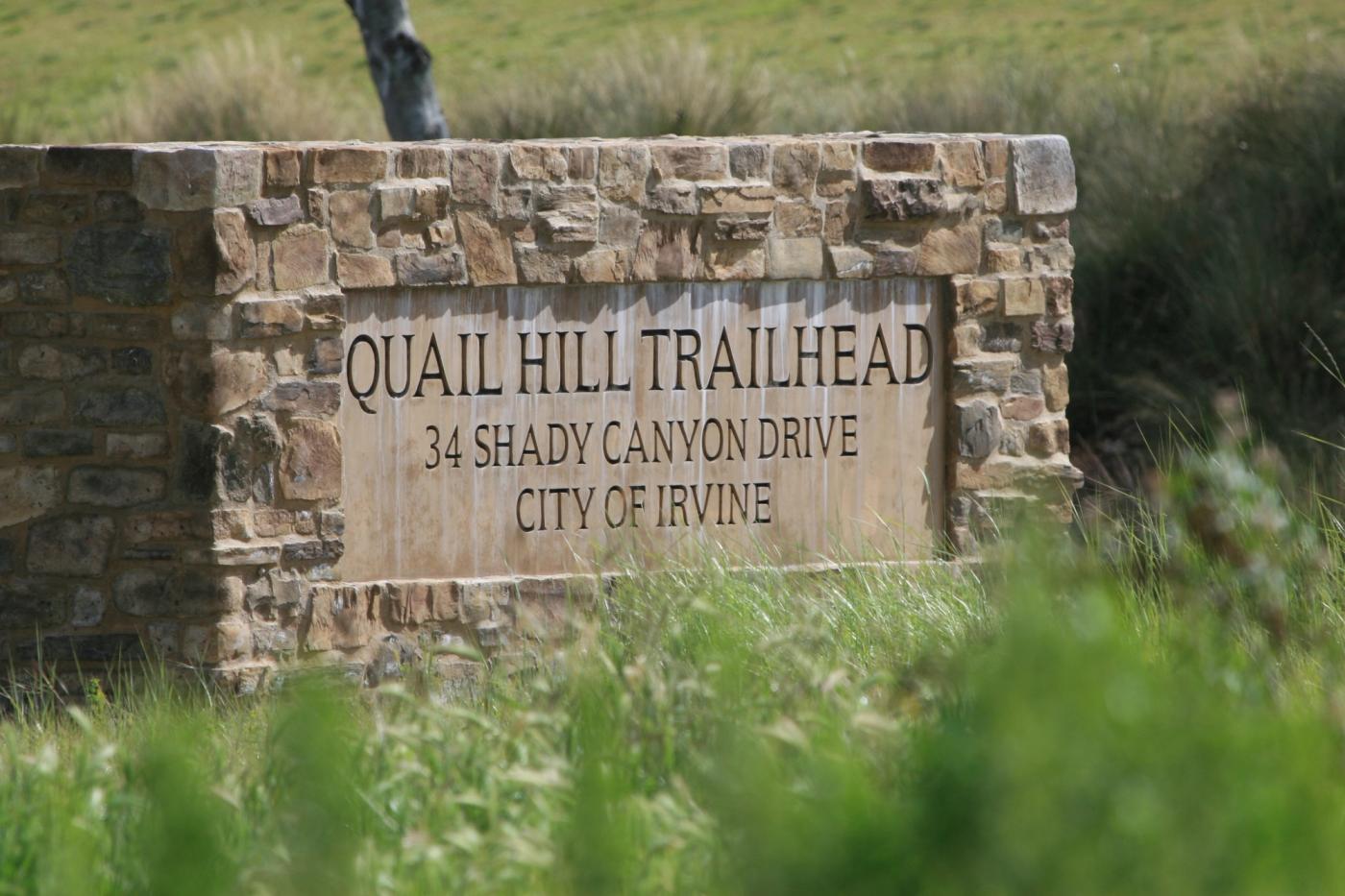 Quail Hill trailhead with open grassland rising toward the ridge