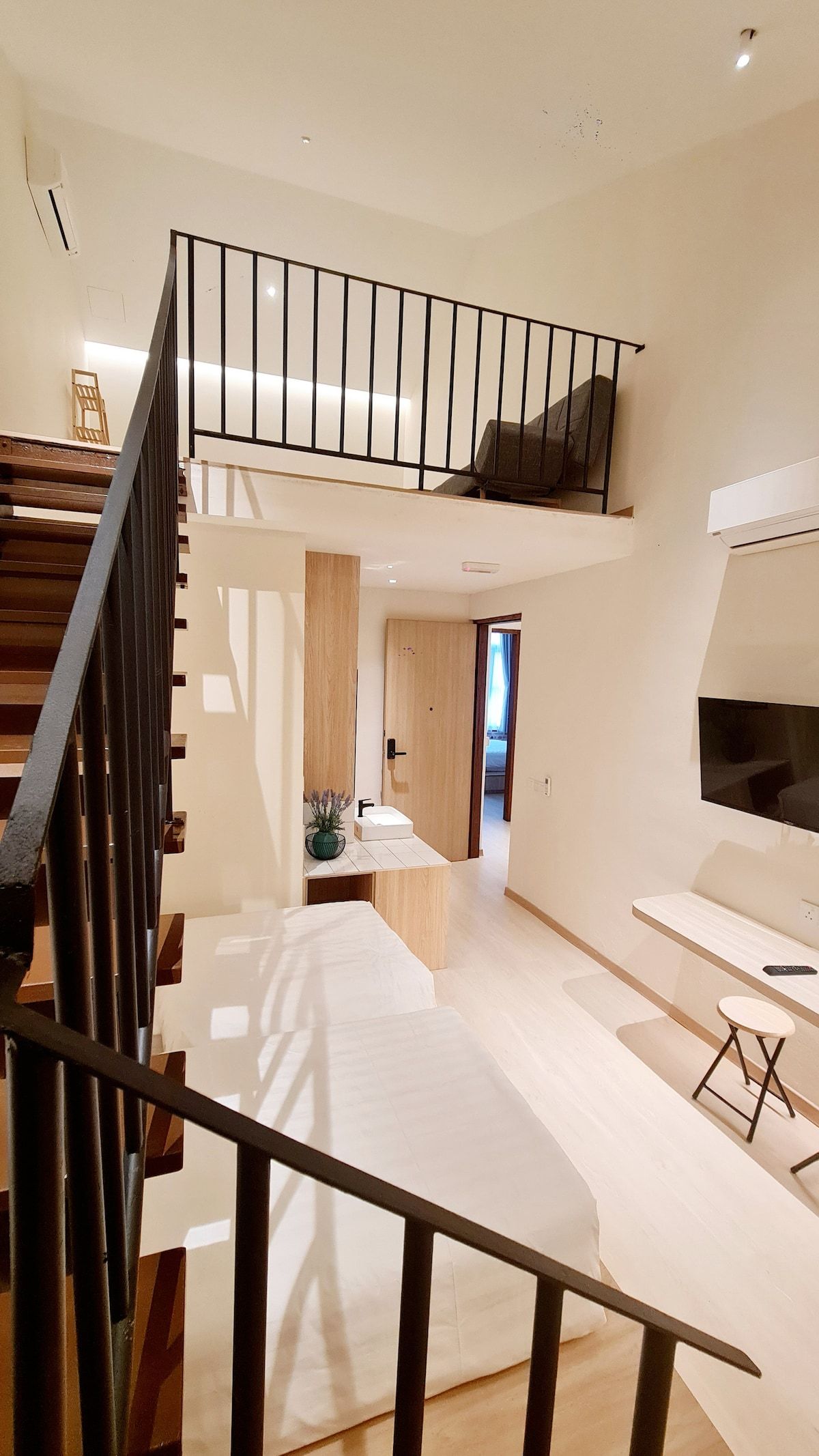 Kazuki duplex room angle with stairs and upper mezzanine