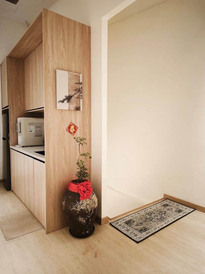 Kazuki heritage entrance hallway with bonsai and kitchenette