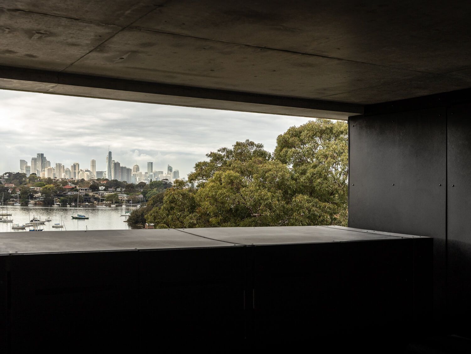 Concrete roof terrace framing the harbour and city skyline