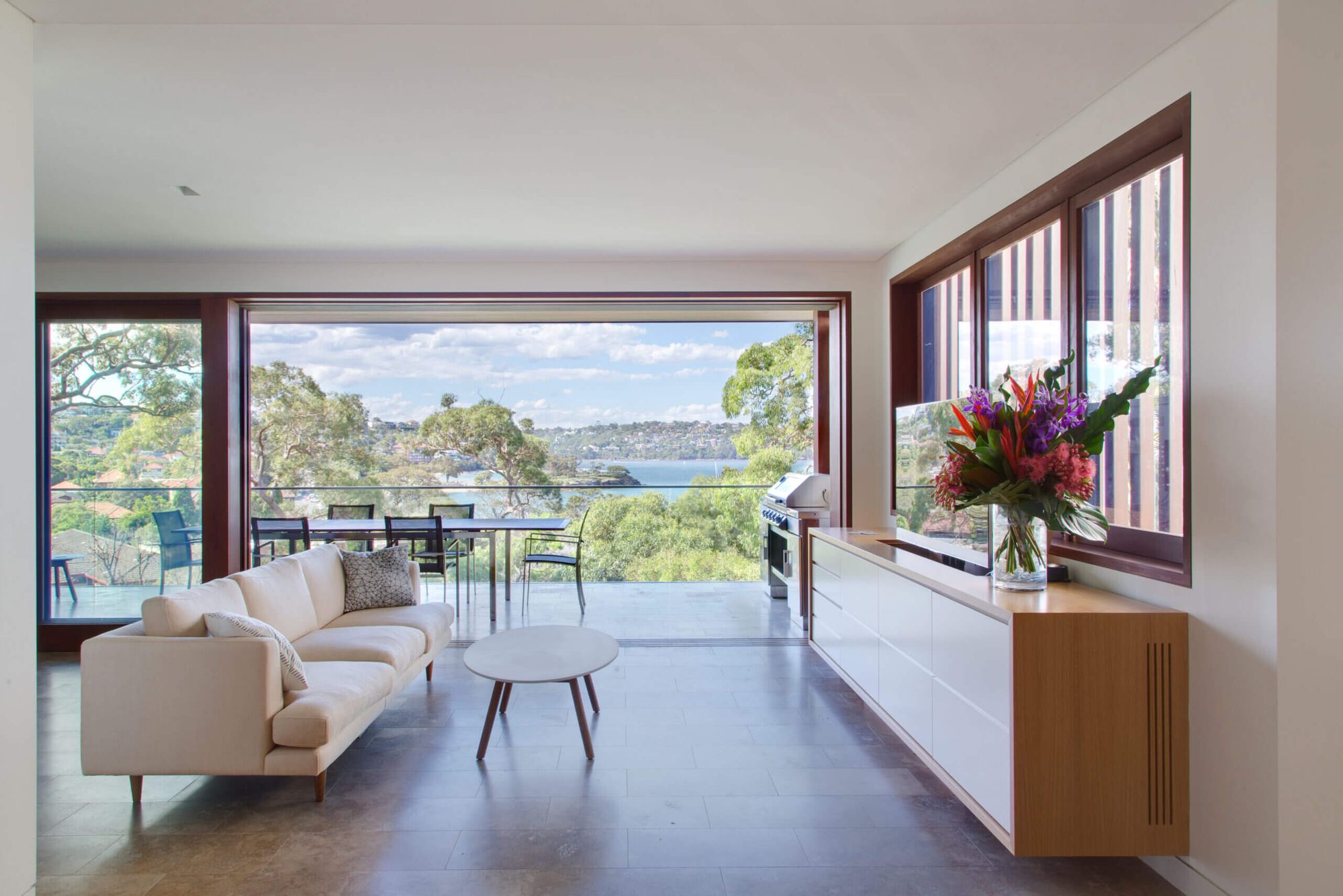 Living room at Quiet House opening to a terrace over the water