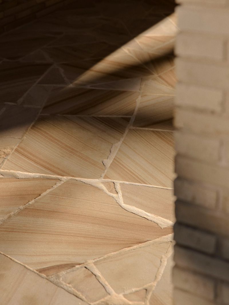 Sandstone paving detail meeting a brick wall