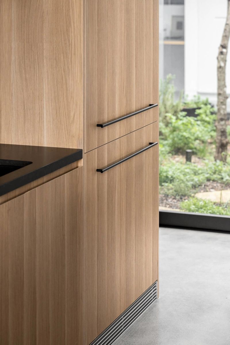 Timber kitchen joinery beside a window to the garden