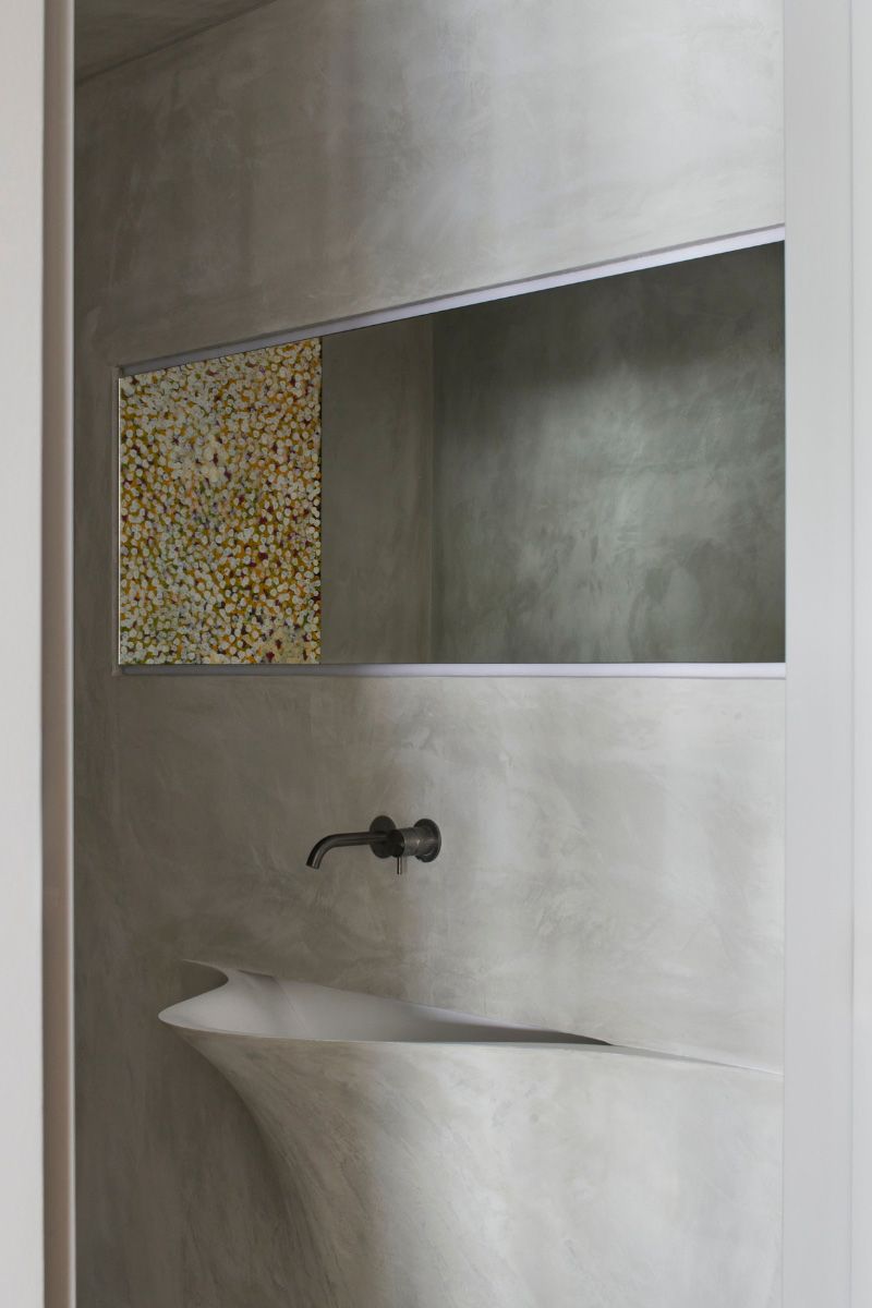 Rendered powder room with a sculpted basin and a mosaic niche