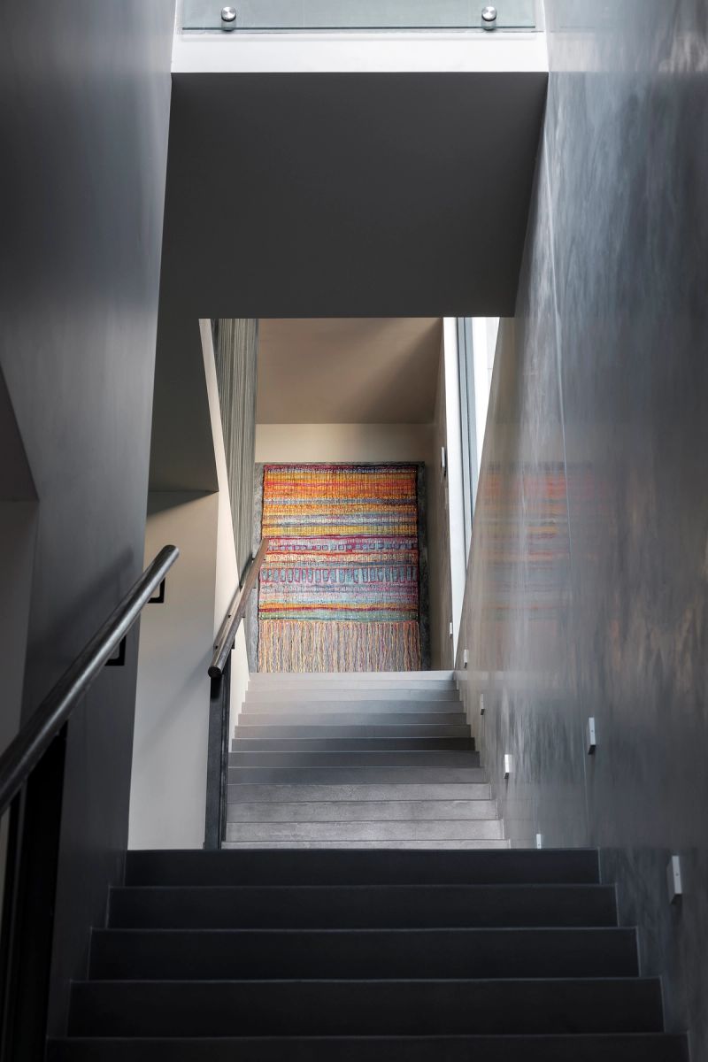 Stair at Shellbank House rising to a striped abstract artwork