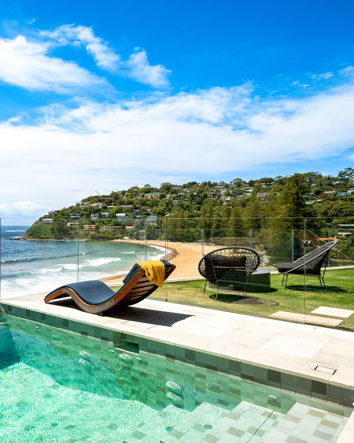 Pool terrace with loungers overlooking the beach at Palm Beach