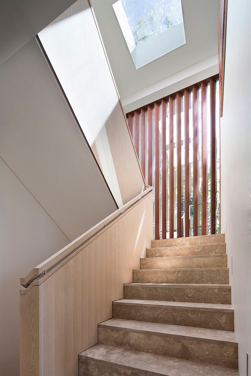 Stone stair beneath a skylight with a timber batten screen